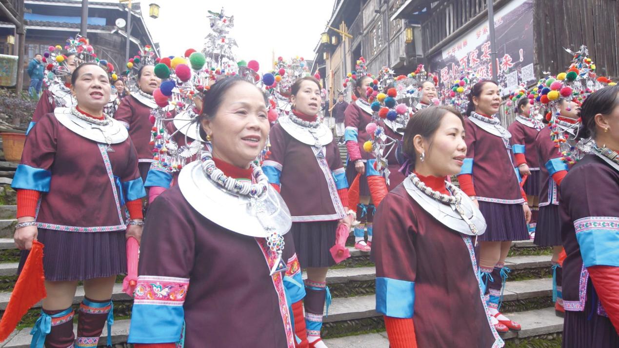 Women from the Dong ethnic group welcome guests with festive songs before the feast